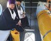 Ушло 100 литров святой воды: в РФ священники освятили район с вертолета (фото)