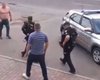 Ударил в лицо и залез на капот: в Киеве мужчина устроил драку с полицейскими (фото, видео)