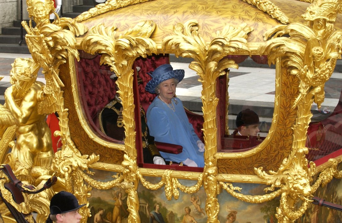 Queen Elizabeth II arrives for a thanksgiving service in a golden carriage