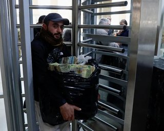 У Сирії жителі несуть в банки сміттєві мішки з грошима: що сталося (фото)