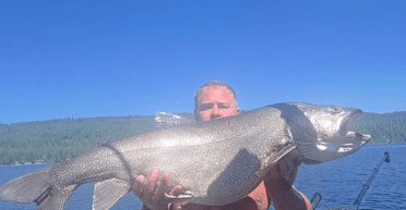 Справжній гігант: чоловік упіймав в озері величезну форель і побив рекорд (фото)