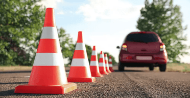 На зло сусідові: чоловік прикрутив болтами дорожні конуси до асфальту