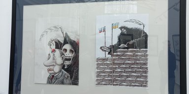 Нутро войны. В Киеве открылась выставка жестких карикатур на Путина (фото)