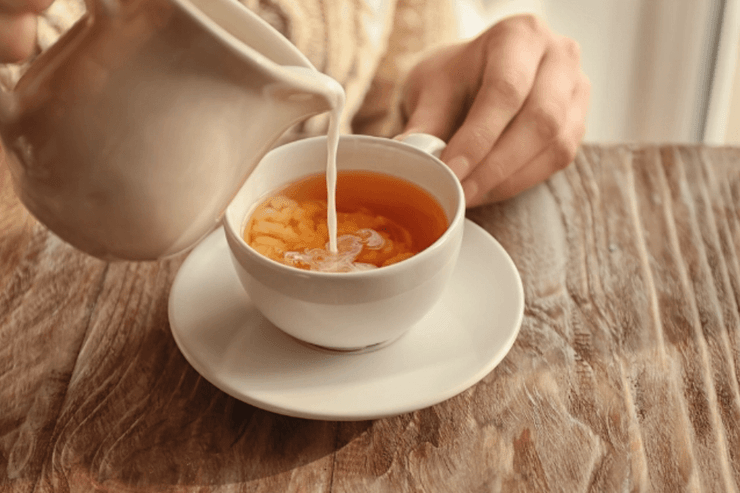 Чай у чашці, в який правильно додають молоко після заварювання