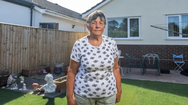Пенсіонерка Дженні Філд у дворі свого будинку в Хемворті, Дорсет, після рішення суду про продаж житла для виплати компенсації