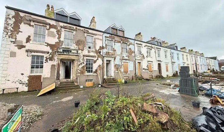 Застарілі вікторіанські будинки з пошкодженими фасадами, приготовані до реконструкції