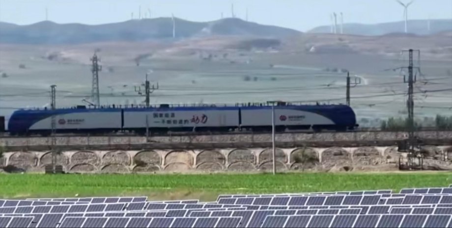 Поезд едет по железной дороге в Китае, питаемый солнечной энергией