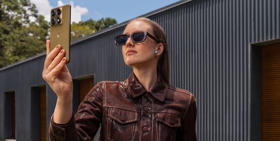 Дівчина тримає смартфон Motorola Signature