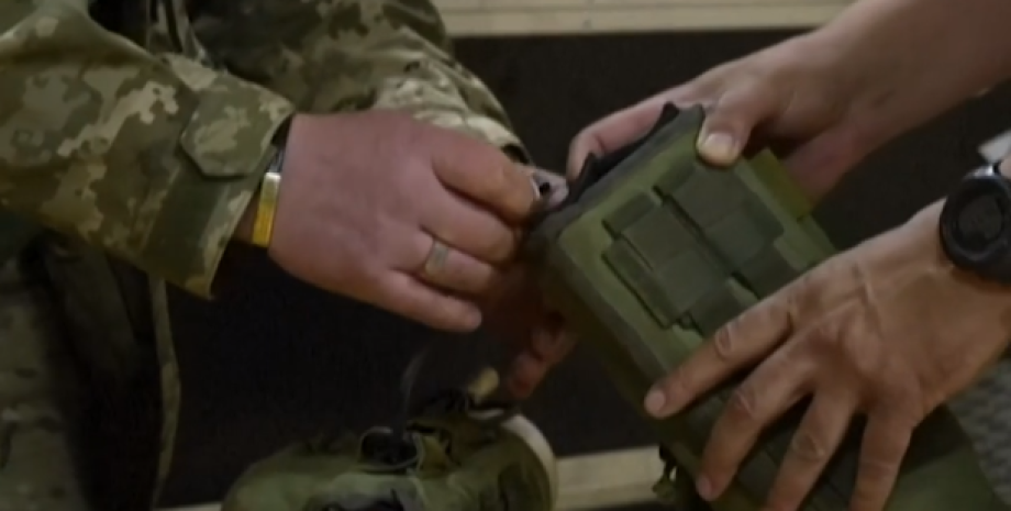 Ukrainian defenders use 4-pound devices against enemy drones, which are attached...