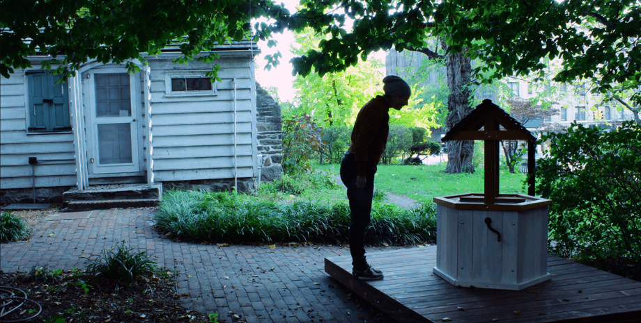 Жінка стоїть біля колодязя бажань у національному парку під час прогулянки