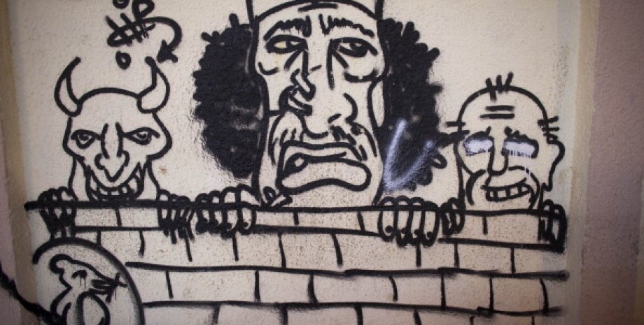Карикатура на Муаммара Каддафи на стене в Ливии / Фото: Getty Images