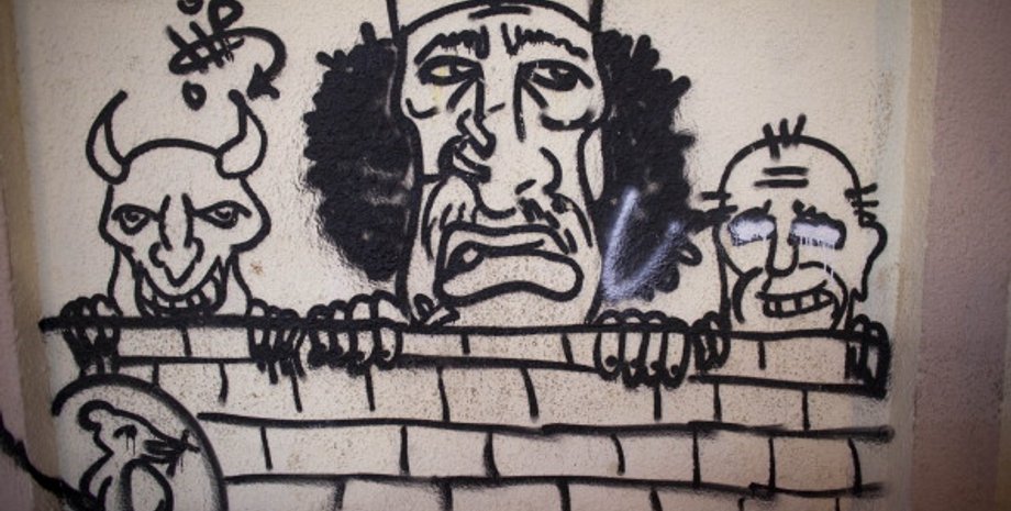 Карикатура на Муаммара Каддафи на стене в Ливии / Фото: Getty Images