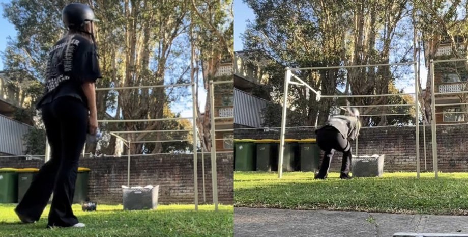 Молодая женщина в Австралии развешивает белье во дворе в защитном шлеме, чтобы избежать нападения птицы-мясника