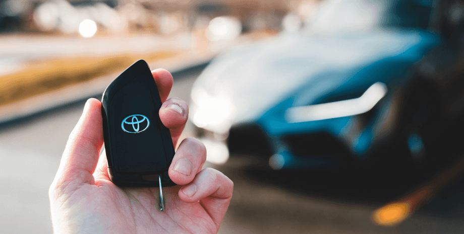 Мужчина держит ключ от машины Toyota