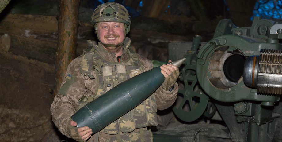 Украинский артиллерист Артиллерист со снарядом и пушкой на позиции