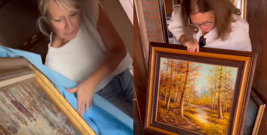 Женщина достает картину из стены во время ремонта и демонстрирует найденное полотно с осенним пейзажем