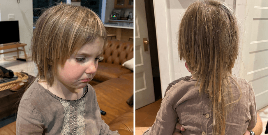 Маленька дівчинка з короткою нерівною стрижкою плаче через зрізане волосся