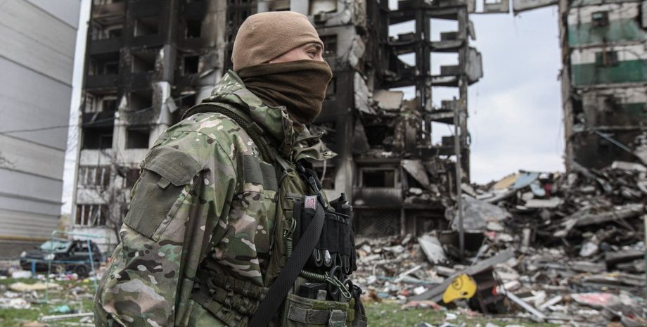 Украинский военный , разрушенный дом.