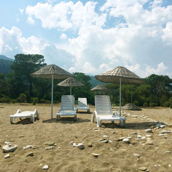 Минимализм во всем. На пляже нет развернутой инфраструктуры — лишь шезлонги и зонтики