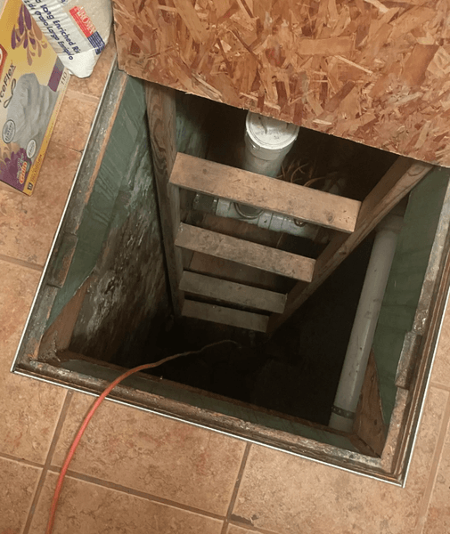 Відчинений навстіж погріб у будинку