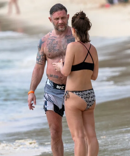 Tom Hardy with his wife on the beach in Barbados